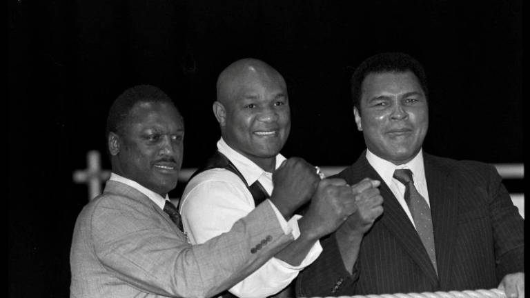 Boxers Joe Frazier, George Foreman and Muhammad Ali, raise fists at launch of film Champions Forever exploring their lives London. October 17, 1989 REUTERSpix