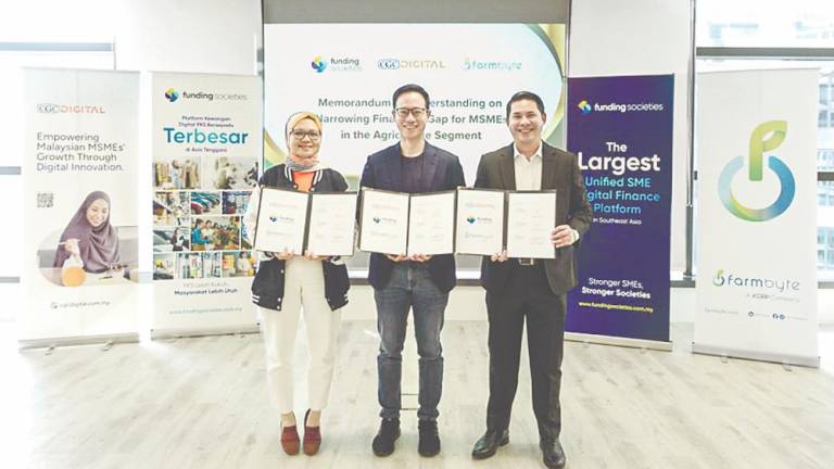 From left: Yushida Husin, Wong, and Syed Aiman Kifli after the MoU signing ceremony.