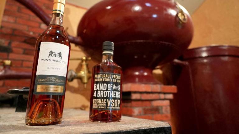 Bottles of Cognac and a still are seen in the Painturaud Freres wine cellar in Segonzac, France, October 9, 2024. - REUTERSPIX