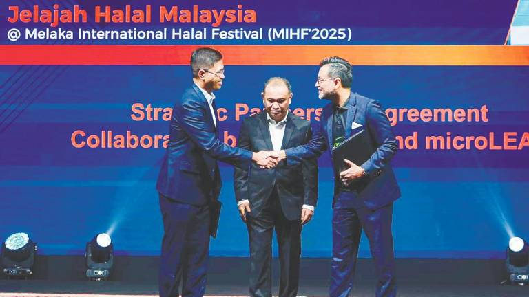 HDC and microLEAP representatives exchange documents to mark their strategic partnership agreement.