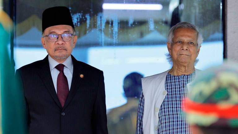 Prime Minister Datuk Seri Anwar Ibrahim (left) is welcomed by Bangladesh’s interim Chief Adviser, Dr Muhammad Yunus, upon arrival at Hazrat Shahjalal International Airport for an official visit to Bangladesh on 4 October 2024. – BERNAMA