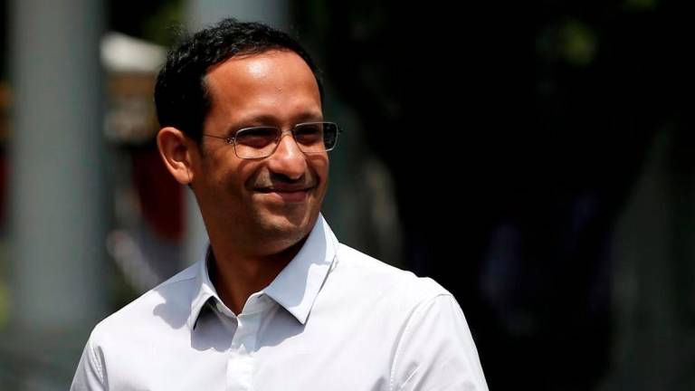 Nadiem Makarim, founder of the Indonesian ride-hailing and online payment firm Gojek waves to journalists as he arrives at the Presidential Palace in Jakarta, Indonesia, October 21, 2019. - REUTERS