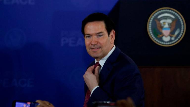 U.S. Secretary of State Marco Rubio adjusts his tie ahead of joint press conference by U.S. President Donald Trump and Russian President Vladimir Putin, following their meeting to negotiate an end to the war in Ukraine, at Joint Base Elmendorf-Richardson in Anchorage, Alaska, U.S., August 15, 2025. REUTERS/Jeenah Moon