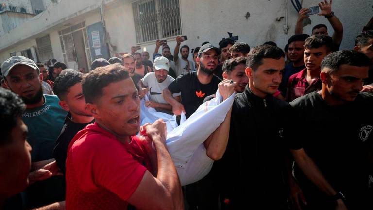 Mourners carry a body as they attend the funeral of Palestinians killed in overnight Israeli strikes, according to medics, at Al-Shifa Hospital in Gaza City, July 11, 2025. - REUTERSPIX