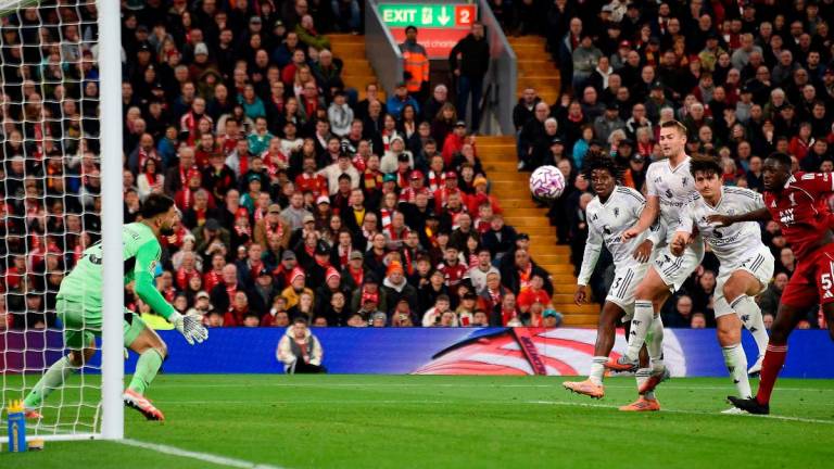 Manchester United’s English defender #05 Harry Maguire scores the team’s second goal during the English Premier League football match between Liverpool and Manchester United at Anfield in Liverpool. - PETER POWELL / AFP