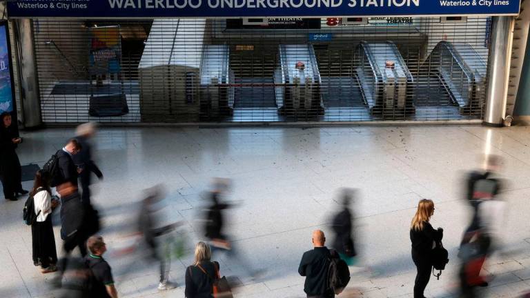 Travellers pause and walk past a closed London Underground entrance during the morning rush hour, as London Tube rail strikes continue, at Waterloo Station in London, Britain, September 8, 2025. REUTERS/Toby Melville TPX IMAGES OF THE DAY