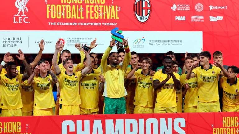 AC Milan players celebrate with a trophy after the match - REUTERSpix
