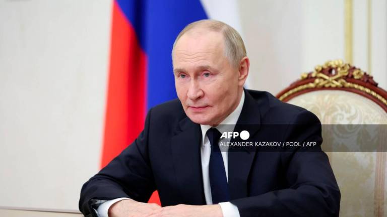 In this pool photograph distributed by the Russian state agency Sputnik, Russia's President Vladimir Putin addresses the participants of the final stage of the 5th International Financial Security Olympics via video link in Moscow on September 29, 2025. - Alexander Kazakov/Pool/AFPPIX