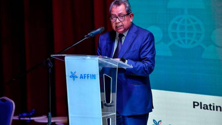 Securities Commission (SC) chairman Datuk Seri Dr Awang Adek Hussin delivering his key note address at the Annual Signature Financial Planning Symposium 2024 at Affin Tower, Tun Razak Exchange today. - fotoBERNAMA