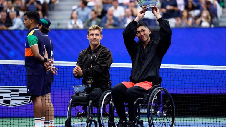 Japan’s Tokito Oda holds his trophy next to runner-up Gustavo Fernandez of Argentina after winning the men’s wheelchair singles final tennis match. - CHARLY TRIBALLEAU / AFP