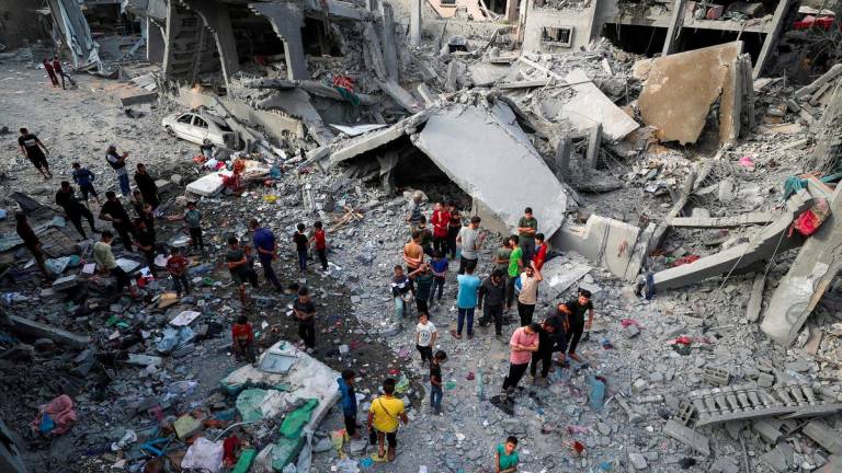 Palestinians inspect the site of an Israeli strike on a house, in Jabalia, northern Gaza Strip May 18, 2025. - REUTERSPIX
