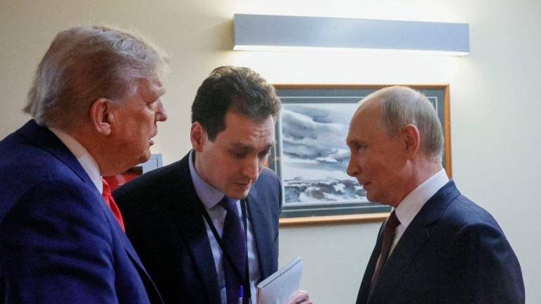 In this pool photograph distributed by the Russian state agency Sputnik, US President Donald Trump (L) and Russian President Vladimir Putin (R) chat before holding a joint press conference following a US-Russia summit on Ukraine at Joint Base Elmendorf-Richardson in Anchorage, Alaska, on August 15, 2025. (Photo by Gavriil GRIGOROV / POOL / AFP)