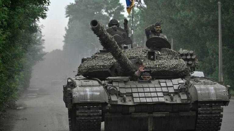 Ukrainian servicemen ride on a tank in Donetsk region on June 28, 2023, amid the Russian invasion of Ukraine. - AFPPIX