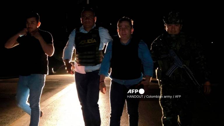 Handout picture released by Colombian Army press office shows Congressman Julio Cesar Triana (2nd R) being escorted by Colombian armed forces in Neiva, Huila department, Colombia on August 13, 2025. - AFP PHOTO / COLOMBIAN ARMY / HANDOUT