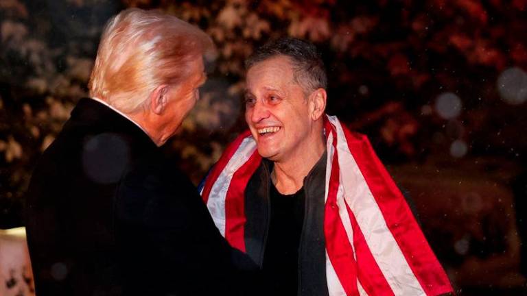 US President Donald Trump greets former detainee Marc Fogel as he arrives at the White House in Washington, DC, on February 11, 2025. - AFPPIX