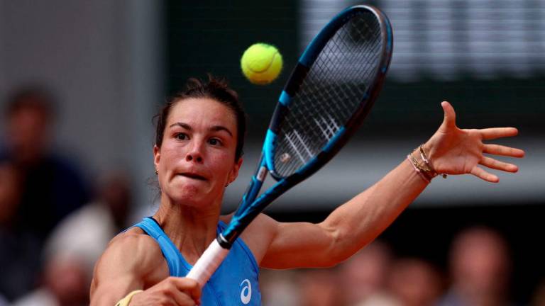 France’s Lois Boisson plays a backhand return to US Jessica Pegula during their women’s singles match on day 9 of the French Open tennis tournament on Court Philippe-Chatrier at the Roland-Garros Complex in Paris on June 2, 2025. (Photo by Anne-Christine POUJOULAT / AFP)