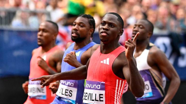 Jamaica’s Oblique Seville celebrates after winning the Men’s 100m final ahead of Noah Lyles of the U.S. REUTERS/Dylan Martinez TPX IMAGES OF THE DAY