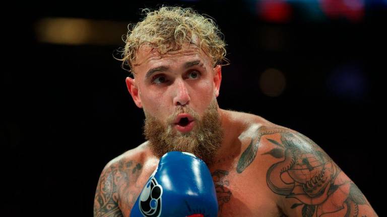 USA’s Jake Paul and Mexico’s Julio Cesar Chavez Jr. (off frame) fight during their cruiserweight boxing bout at the Honda Center in Anaheim, California, on June 28, 2025. (Photo by Patrick T. Fallon / AFP)