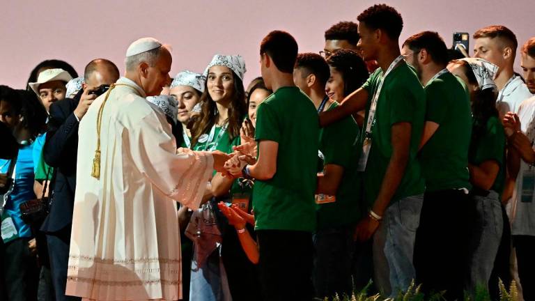Pope Leo XIV (L) speaks with youth and pilgrims during a prayer vigil before Sunday Mass as part of the Jubilee of Youth, in Rome’s eastern Tor Vergata neighbourhood on August 2, 2025. - Filippo MONTEFORTE / AFP