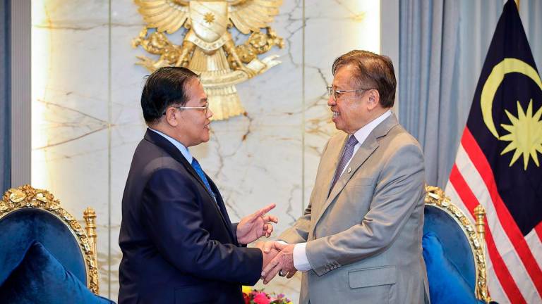 Sarawak Premier Tan Sri Abang Johari Tun Openg receives a courtesy call from Cambodia’s Senior Minister for Special Mission Neak Oknha Datuk Dr Othsman Hassan (left) at his office in the Satria Pertiwi Complex, Petra Jaya, today. – BERNAMA