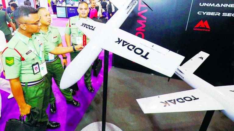 Army personnel examine a bomber drone developed by a local defence tech company during the event. – Adib Rawi Yahya/theSun