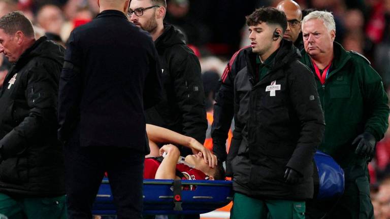 Football - Carabao Cup - Third Round - Liverpool v Southampton - Anfield, Liverpool, Britain - September 23, 2025Liverpool's Giovanni Leoni reacts as he is stretchered off after sustaining an injury as manager Arne Slot looks on - REUTERSPIX