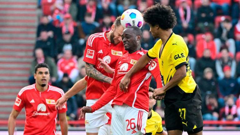 Union Berlin’s German defender #02 Kevin Vogt, Union Berlin’s French defender #26 Jerome Roussillon and Dortmund’s German forward #27 Karim Adeyemi jump for the ball during the German first division Bundesliga football match 1/AFPPix