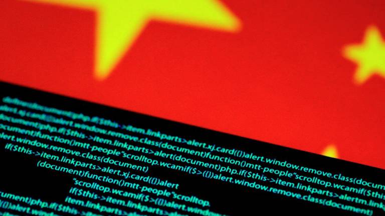 Computer code is seen on a screen above a Chinese flag in this July 12, 2017 illustration photo. - REUTERS