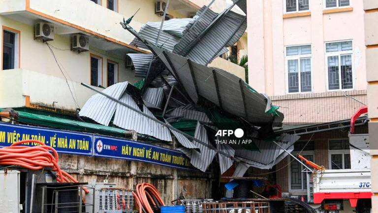 This picture shows a corrugated iron roof blown off after typhoon Bualoi made a landfall in Nghe An province on September 29, 2025. (Photo by Thai An / AFP)