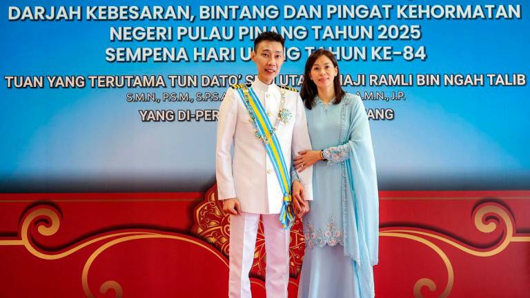 National badminton legend Datuk Seri Lee Chong Wei poses with his wife, Datin Seri Wong Mew Choo, during the Penang state honours ceremony held in conjunction with the governor’s 84th birthday. - Photo by BERNAMA