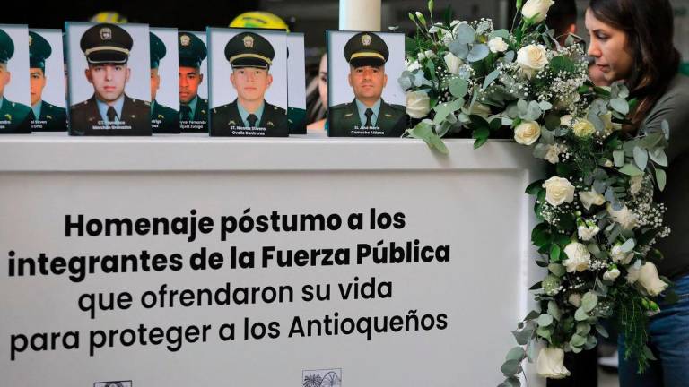 A relative attends during a tribute to 13 slain police officers at the office of the governor of Antioquia in Medellin, Colombia on August 28, 2025. The 13 police officers were killed in a guerrilla attack in Amalfi, Antioquia Department, on August 21, 2025, after a dissident faction of the FARC guerrilla group attacked their coca crop eradication operation in the northwest of the country, the local governor said. (Photo by JAIME SALDARRIAGA / AFP)