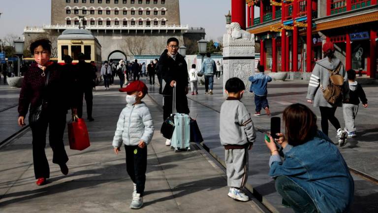 FILE PHOTO: People walk at a tourism site in Qianmen street, Beijing, China March 14, 2023. - REUTERSPIX