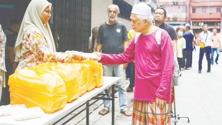 Noralina at a station during one of the food distribution drives. – Adam Amir Hamzah/theSun