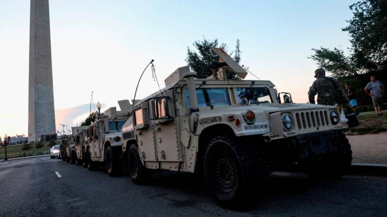 U.S. Army National Guard Humvees park near the Washington Monument after U.S. President Donald Trump announced a federal takeover of the Metropolitan Police Department under the Home Rule Act to assist with crime prevention in the nation's capital, Washington, D.C., August 12, 2025. - REUTERSPIX