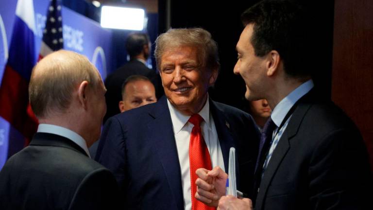 U.S. President Donald Trump talks to Russian President Vladimir Putin after a joint news conference following their meeting at Joint Base Elmendorf-Richardson in Anchorage, Alaska, U.S., August 15, 2025. Sputnik/Gavriil Grigorov/Pool via REUTERS