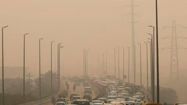 Vehicles drive on a highway on a polluted smoggy morning in New Delhi - REUTERSpix