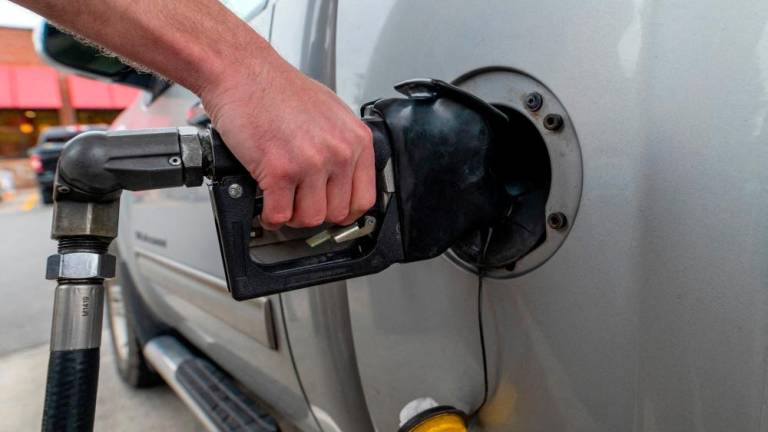 A motorist filling up at a petrol station in Plains, Pennsylvania. US petrol prices rebounded 3.8% in February after declining 3.3% in January. – Reuterspic