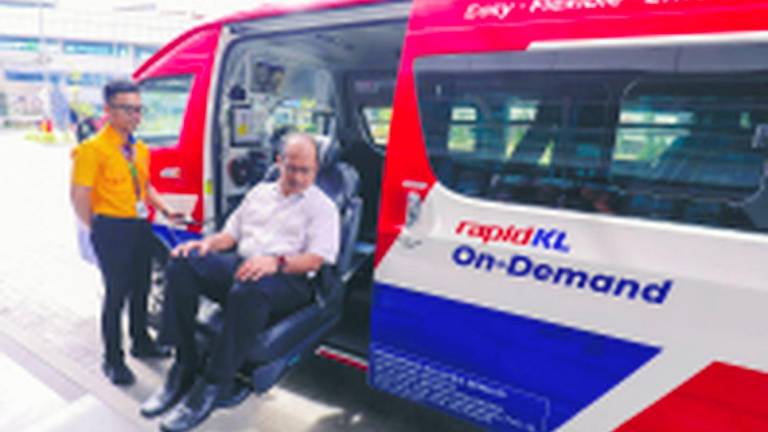 Ku Jamil demonstrating the use of a special seat for wheelchair users and disabled persons. – ADIB RAWI YAHYA/THESUN