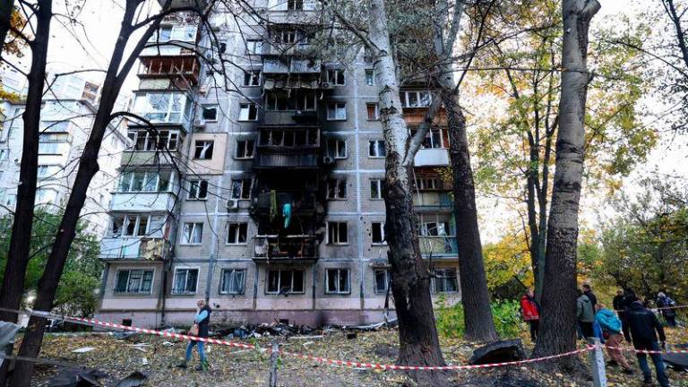 Local residents walk around their multi-story building damaged by the explosion of a drone strike in Kyiv - AFPpix