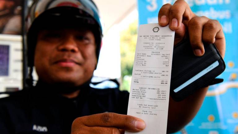 Gambar Hiasan Sahaja: Anggots polis Konstabel Mohamd Azizi Adnan menunjukkan resit subsidi petrol RON95 yang dibeli di stesen minyak Shell Jalan Masjid Negeri pada harga RM1.99 berbanding harga pasaran semasa RM2.05 seliter, menerusi inisiatif BUDI MADANI RON95 (BUDI95) yang bermula hari ini- BERNAMA