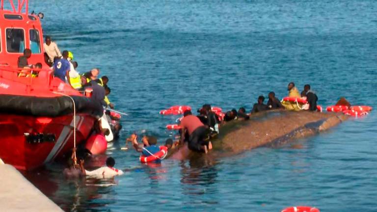 This grab from a handout video released by Television Canaria shows rescuers attempting to save people from drowning after migrants getting ready to disembark their overcrowded boat accidentally capsized the vessel, in the port of La Restinga on the island of El Hierro, Canary Islands, Spain, on May 28, 2025. AFPpix/TV Canaria