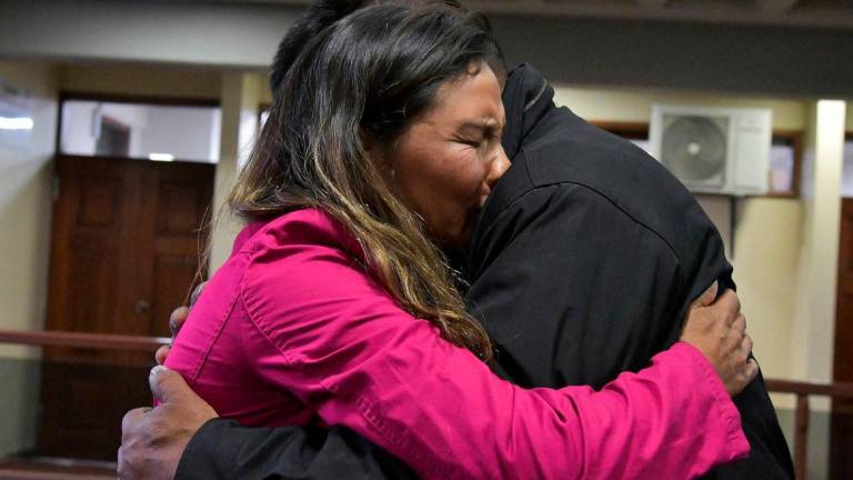 Erika Montano, sister of a Jesuit priest and child abuse victim who died by suicide, hugs a clergy abuse survivor, after a Bolivian court sentenced two elderly Spanish Jesuit priests to a year each in prison for concealing decades of abuse committed by fellow priest Alfonso Pedrajas, who died in 2009, in Cochabamba, Bolivia September 2, 2025. Reuterspix