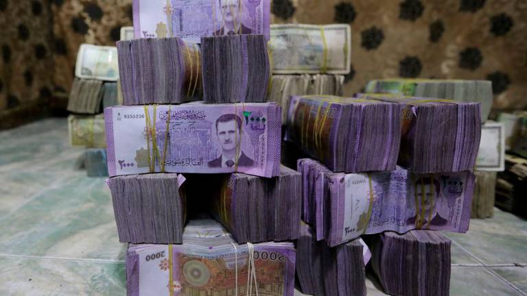 Stacks of Syrian pounds are pictured inside an exchange currency shop in Azaz, Syria February 3, 2020. Picture taken February 3, 2020. - REUTERSPIX