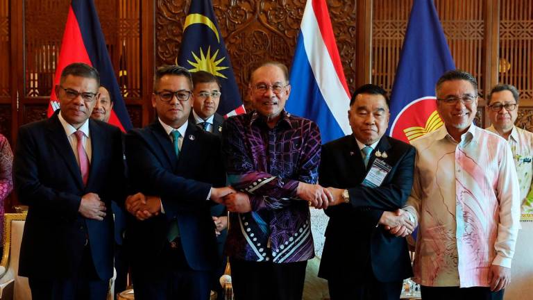 Anwar with (from left) Home Minister Datuk Seri Saifuddin Nasution Ismail, Cambodian Deputy Prime Minister Gen Tea Seiha, Thai Acting Defence Minister Gen Natthaphon Narkphanit and Defence Deputy Minister Adly Zahari at the Perdana Putra Building yesterday. – BERNAMApix