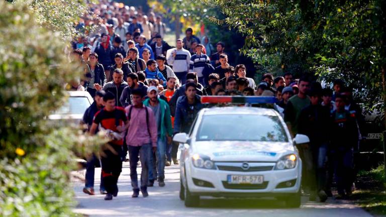 Migrants walk towards the Austrian border after they arrive by train in Hegyeshalom, Hungary September 23, 2015. REUTERS/Leonhard Foeger/File Photo
