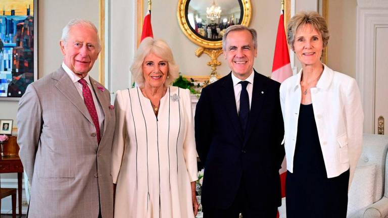 Britain’s King Charles III and Britain’s Queen Camilla pose fir a photograph with Canada’s Prime Minister Mark Carney and his wife Diana Fox Carney, during an audience at Rideau Hall, the official residence of the Governor General of Canada, in Ottawa, on May 26,