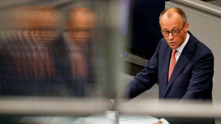 German Chancellor Friedrich Merz is reflected as he gives a speech prior to a general debate on the budget of the Chancellery at the Bundestag, the lower house of parliament, in Berlin, on July 9, 2025. (Photo by Odd ANDERSEN / AFP)