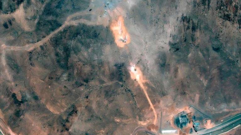 This handout satellite image provided by Maxar Technologies and dated July 1, 2025, shows activity near the perimeter building and southern holes caused by the June 22 US airstrike on the Fordo (Fordow) Fuel Enrichment Plant complex. - AFP PHOTO/ SATELLITE IMAGE ©2024 MAXAR TECHNOLOGIES