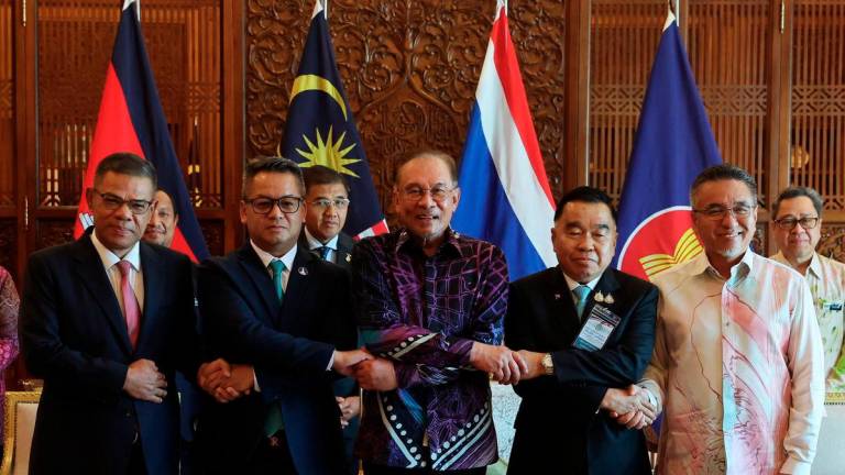 Prime Minister Datuk Seri Anwar Ibrahim (centre) poses for a photo with Deputy Prime Minister and Minister of National Defence General Tea Seiha (second, left), and ThailandÕs Acting Minister of Defence General Natthaphon Narkphanit (second, right) at the Perdana Putra Building on August 7, 2025. Also present were Home Minister Datuk Seri Saifuddin Nasution Ismail (left) and Deputy Defence Minister Adly Zahari (right). - BERNAMA