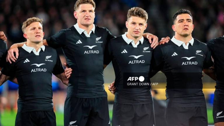 (L to R) New Zealand's Damian McKenzie, Jordie Barrett, Beauden Barrett and Codie Taylor sing the national anthems prior to their second international rugby test match between New Zealand and France at Sky Stadium in Wellington on July 12, 2025. - Grant Down / AFP